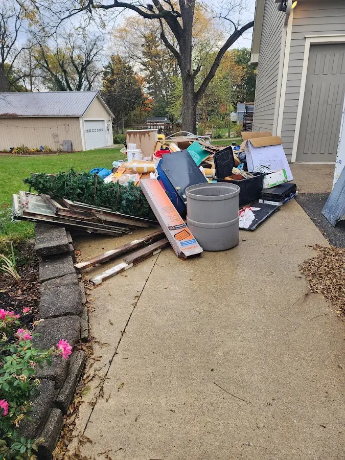 Dumpster being loaded with debris for 12 Yard Dumpster Rental in West Seneca